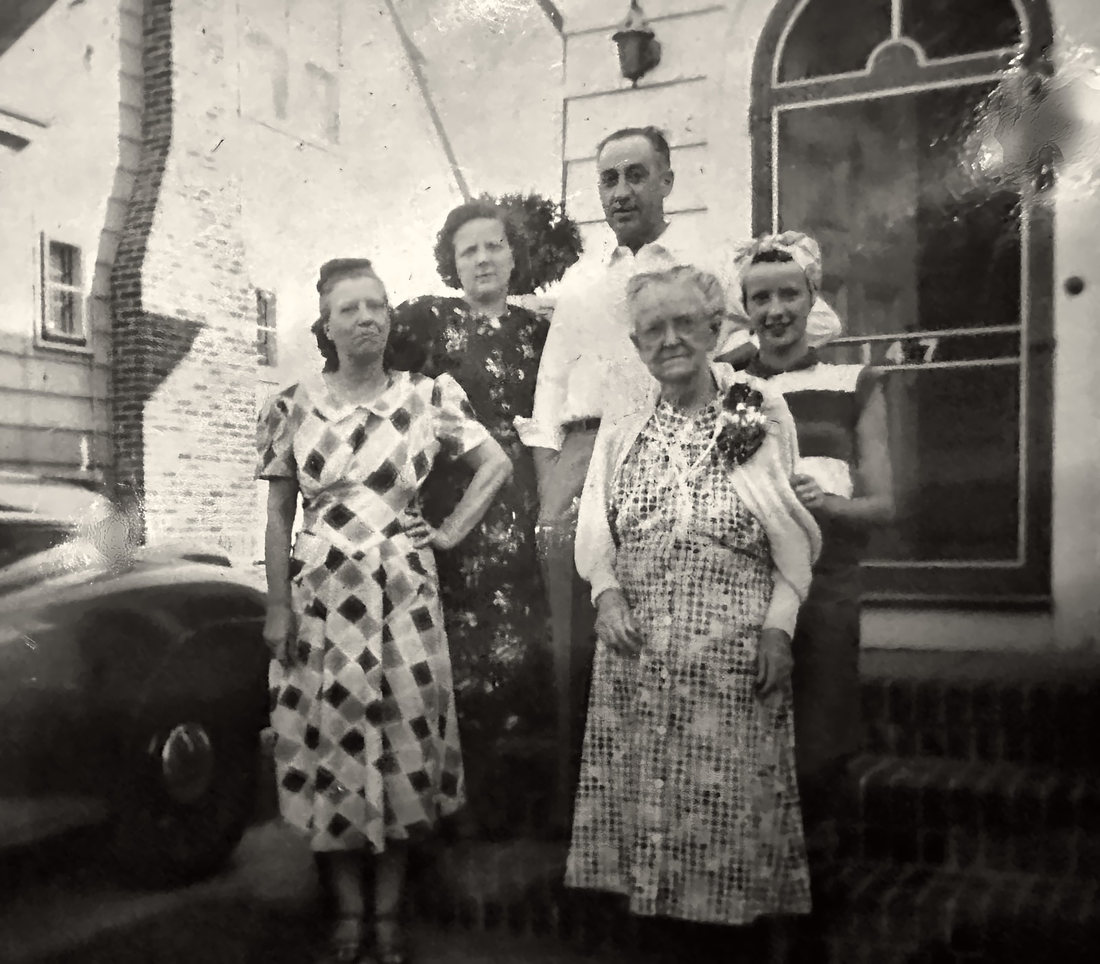 Florence and Hanford Tracy (back), their daughters Maitland and Phyllis (middle), and Florence’s mother, Margaret Ann “Maggie” Miller (front), outside a house Florence and Hanford Tracy (back), their daughters Maitland and Phyllis (middle), and Florence’s mother, Margaret Ann “Maggie” Miller (front), outside a house